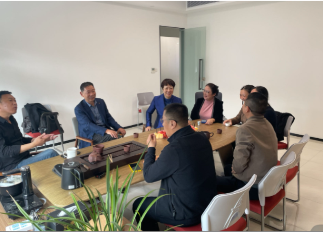 A group of people sitting around a table

Description automatically generated