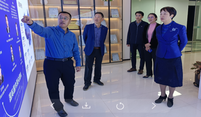 A group of people standing in front of a glass wall

Description automatically generated